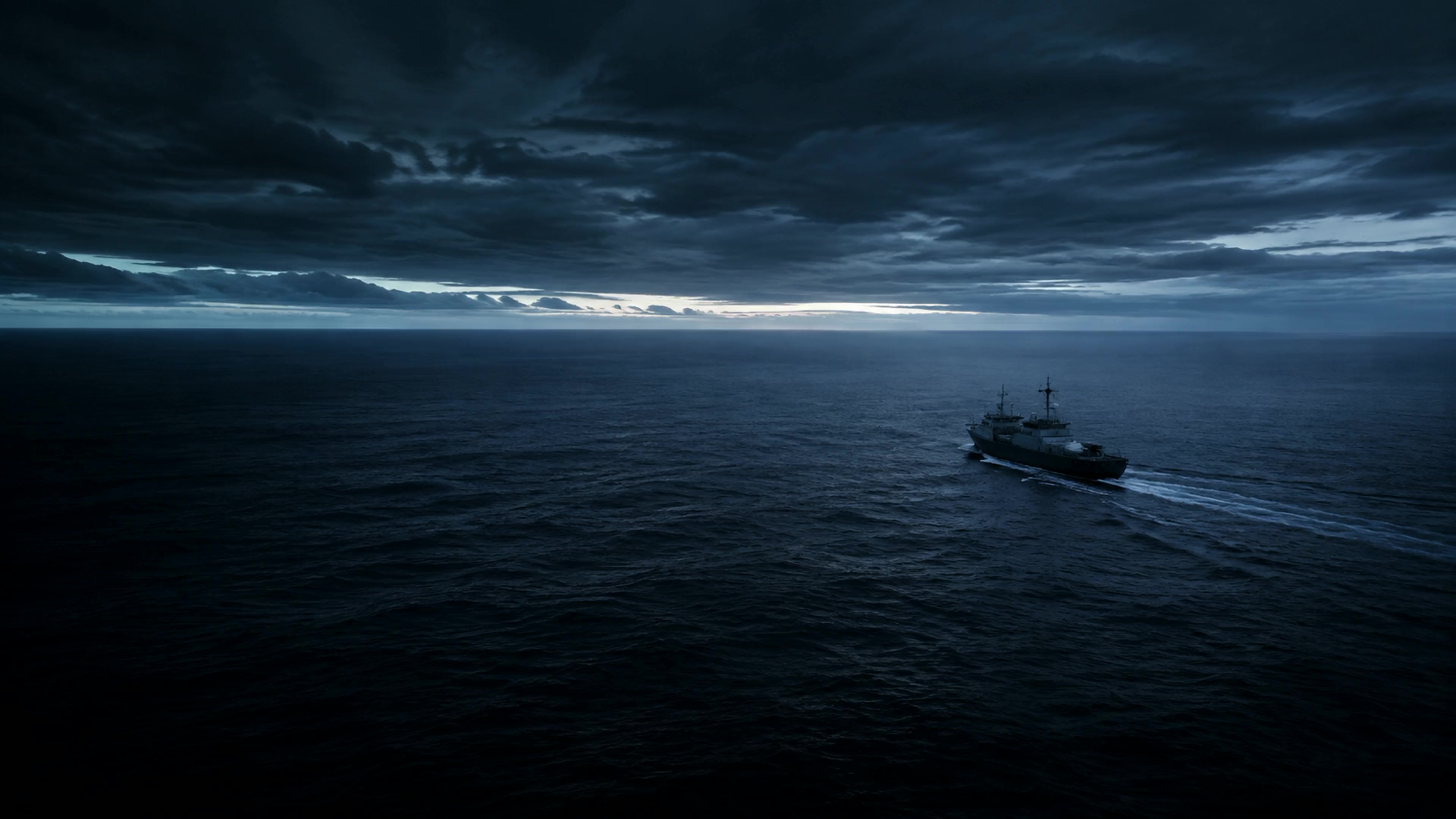 A vessel crossing open water at blue hour